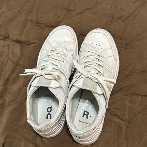 On shoes the Roger all white